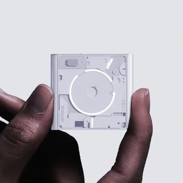 Minimal white hardware product held in a hand